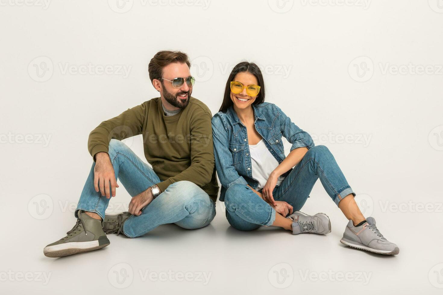 stylish couple sitting on floor in jeans photo