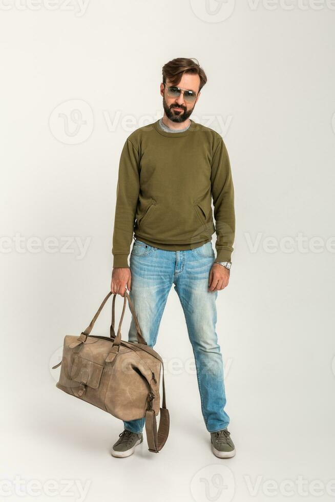 attractive stylish man traveler standing with bag photo