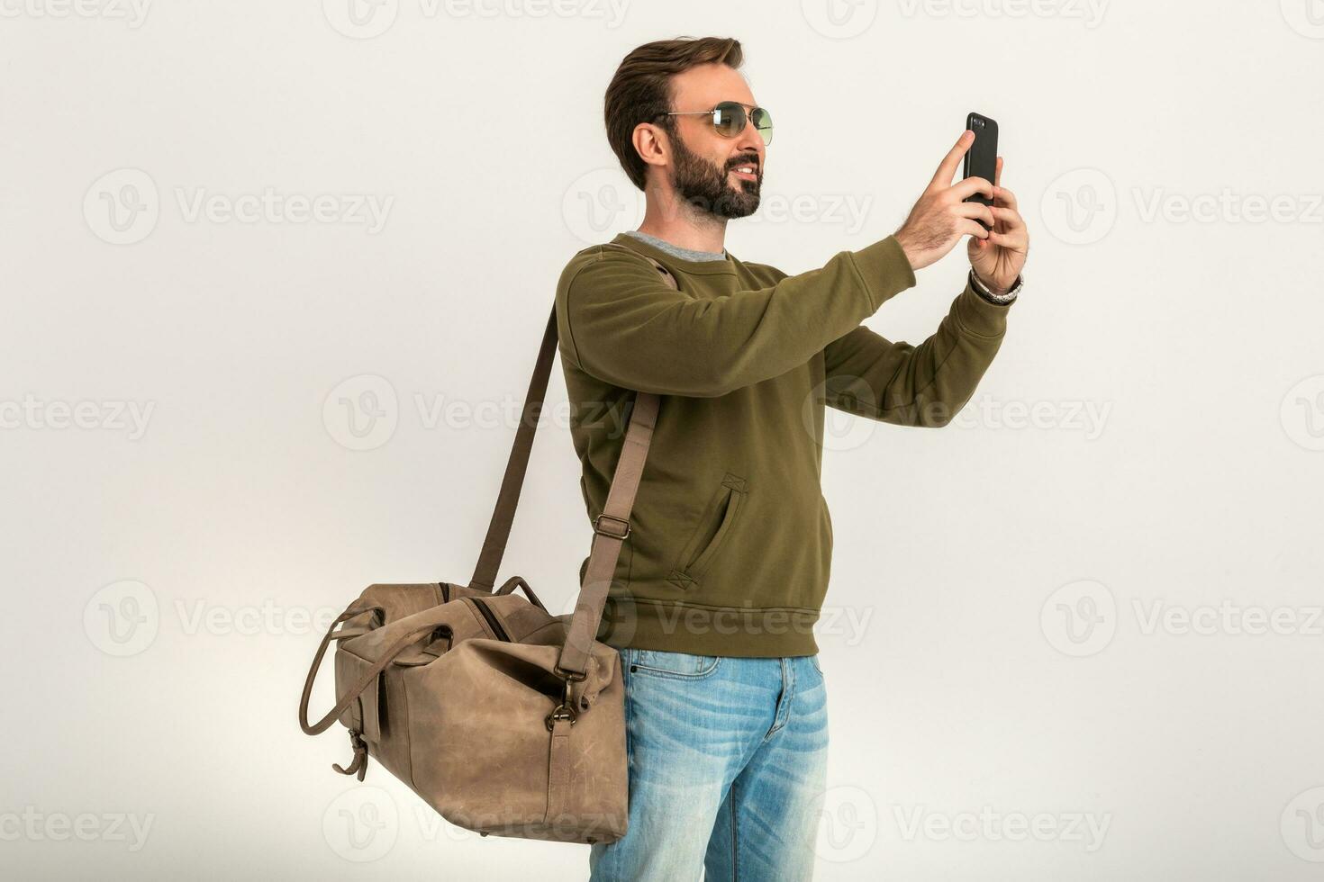 attractive stylish man traveler standing with bag photo