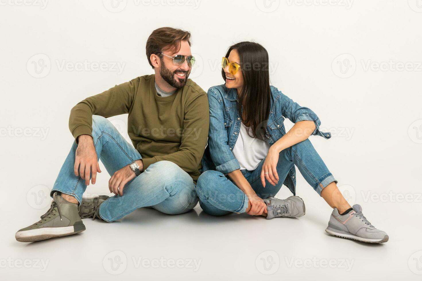 stylish couple sitting on floor in jeans photo