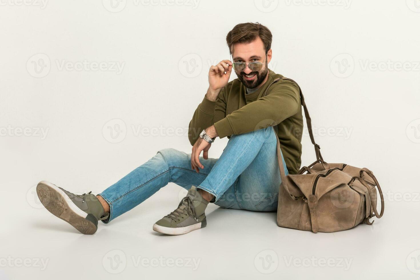 hansome bearded stylish man sitting on floor photo