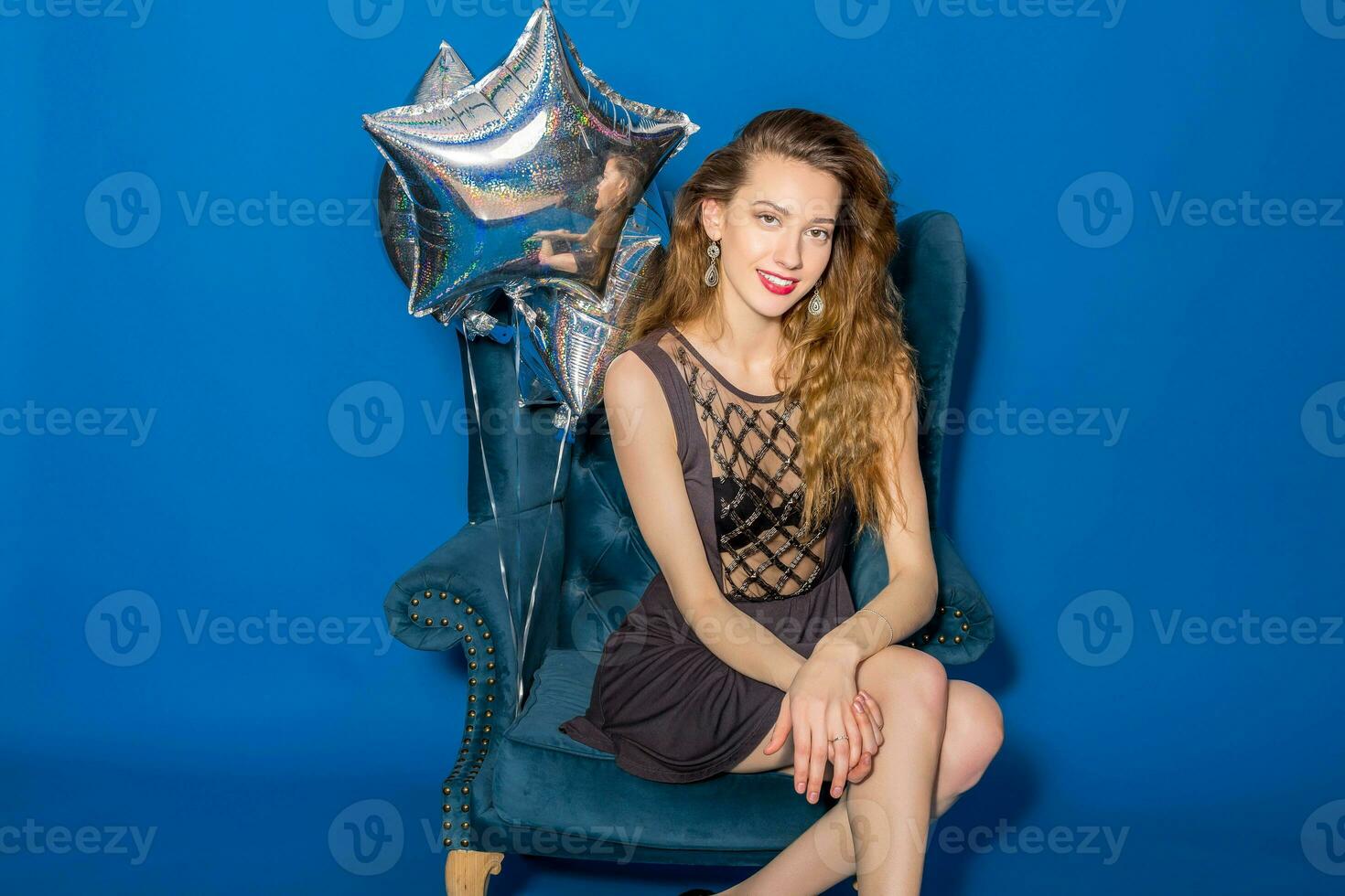 young hipster beautiful woman, evening dress, trend fashion style sitting in chair photo