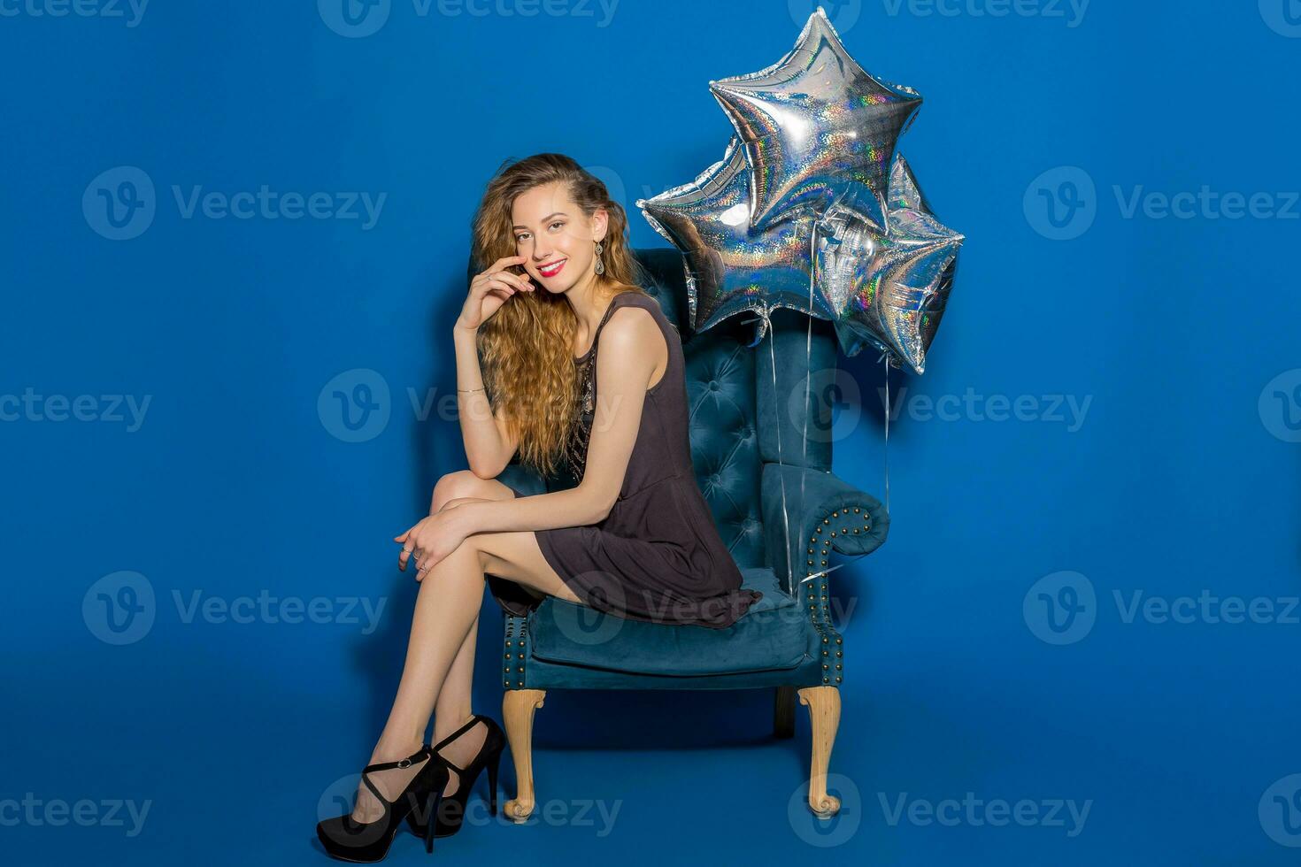 young hipster beautiful woman, evening dress, trend fashion style sitting in chair photo