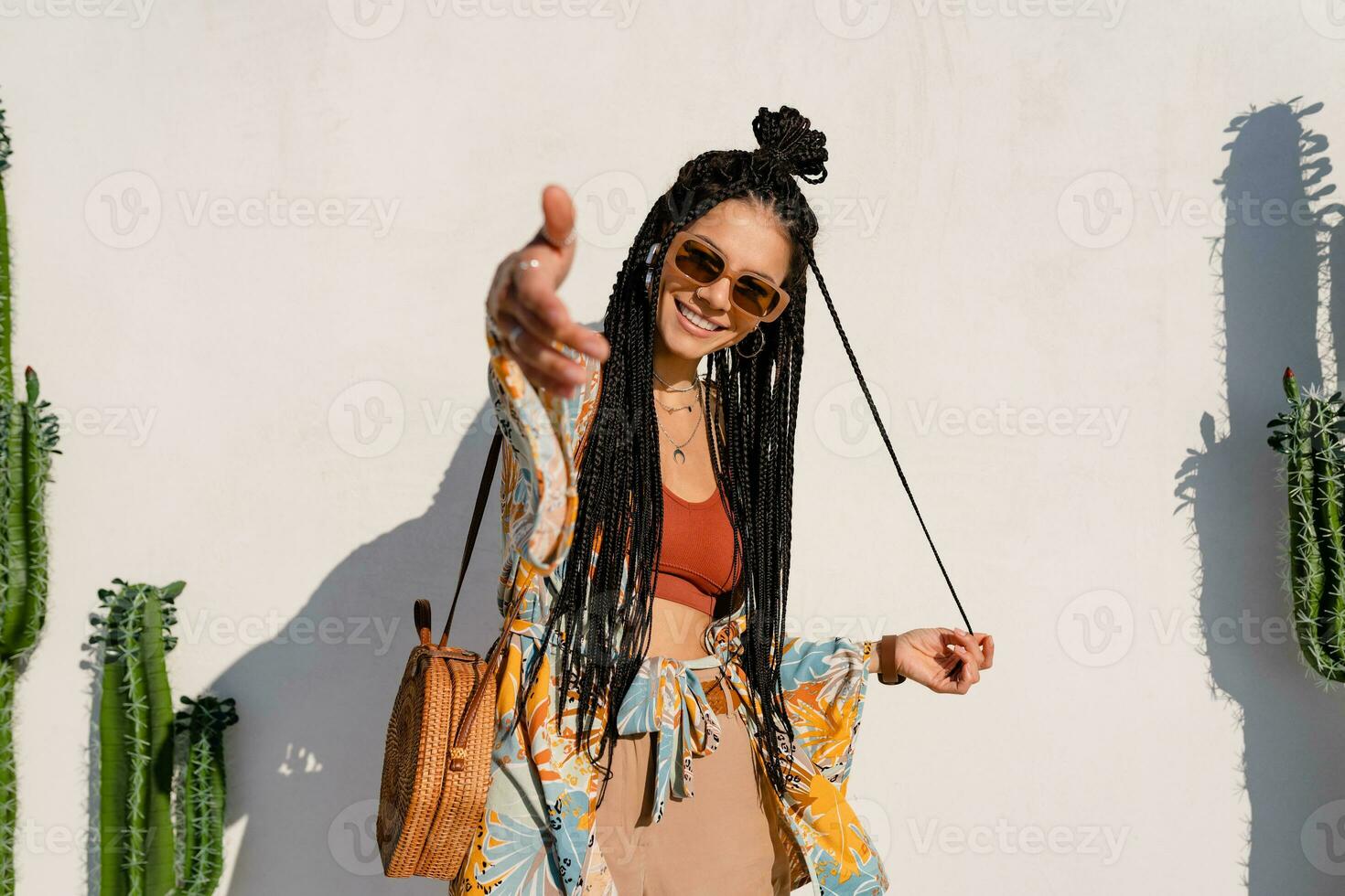 stylish pretty woman with african braids on sunny summer vacation photo