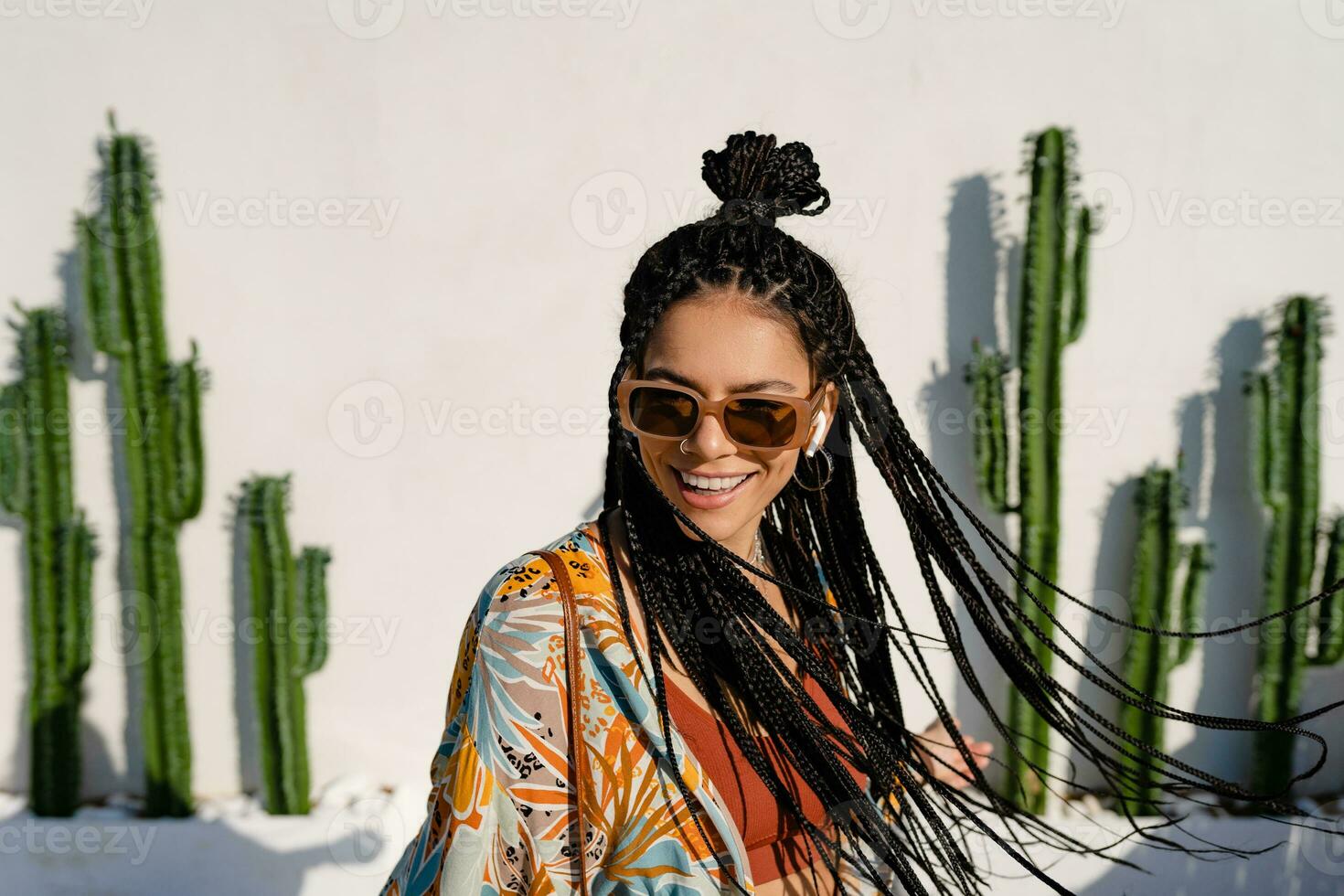 stylish pretty woman with african braids on sunny summer vacation photo