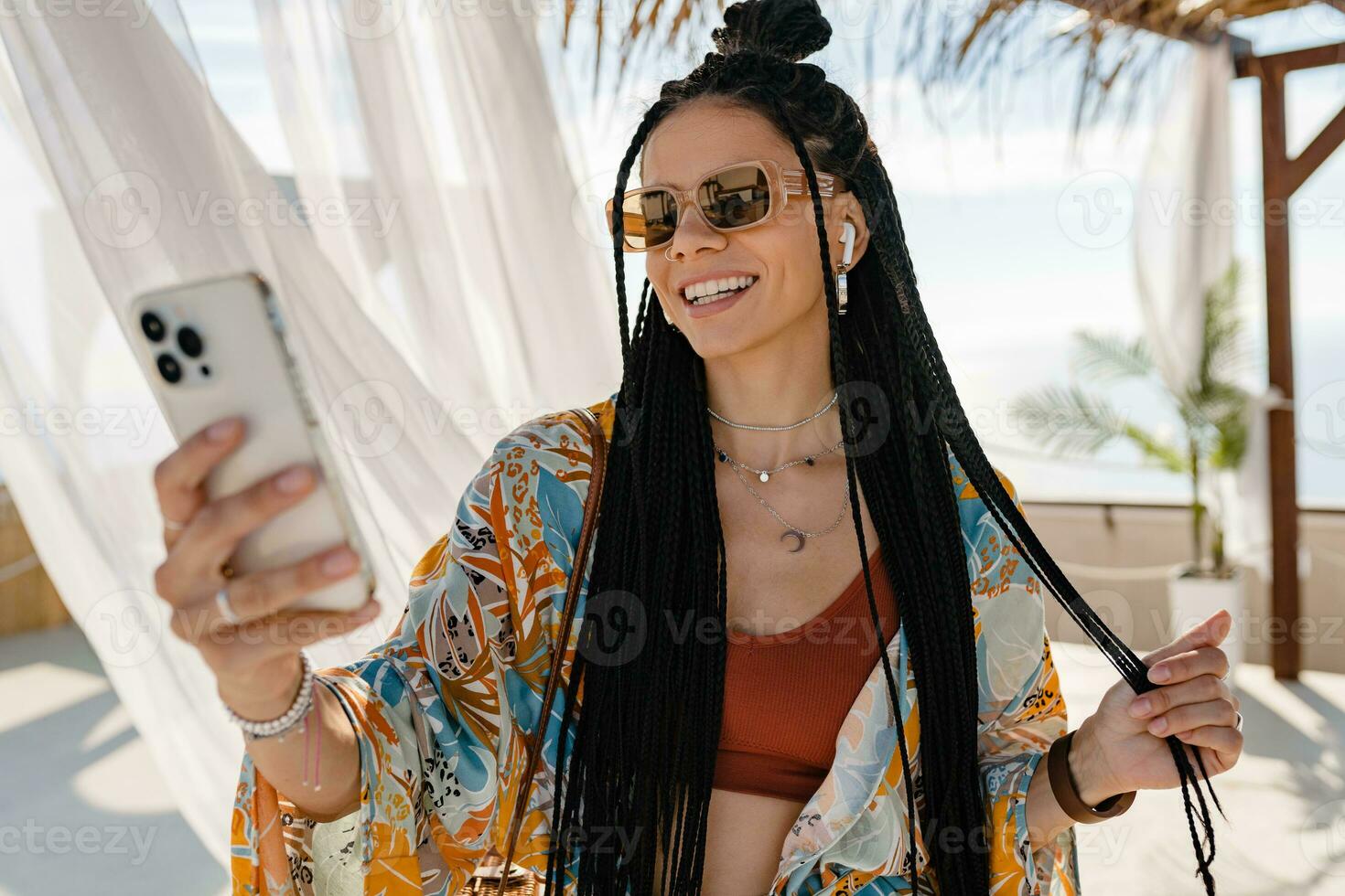 stylish pretty woman with african braids on sunny summer vacation photo