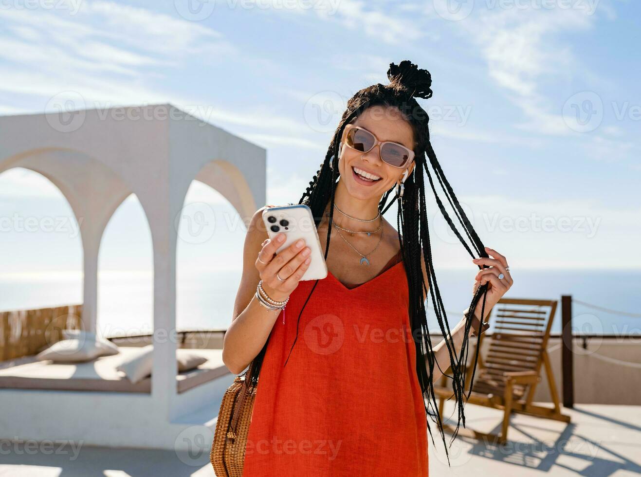 stylish pretty woman with african braids on sunny summer vacation photo