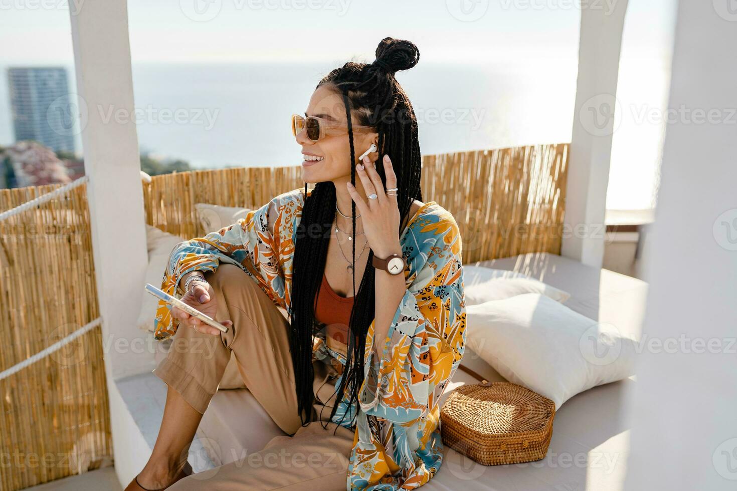 stylish pretty woman with african braids on sunny summer vacation photo