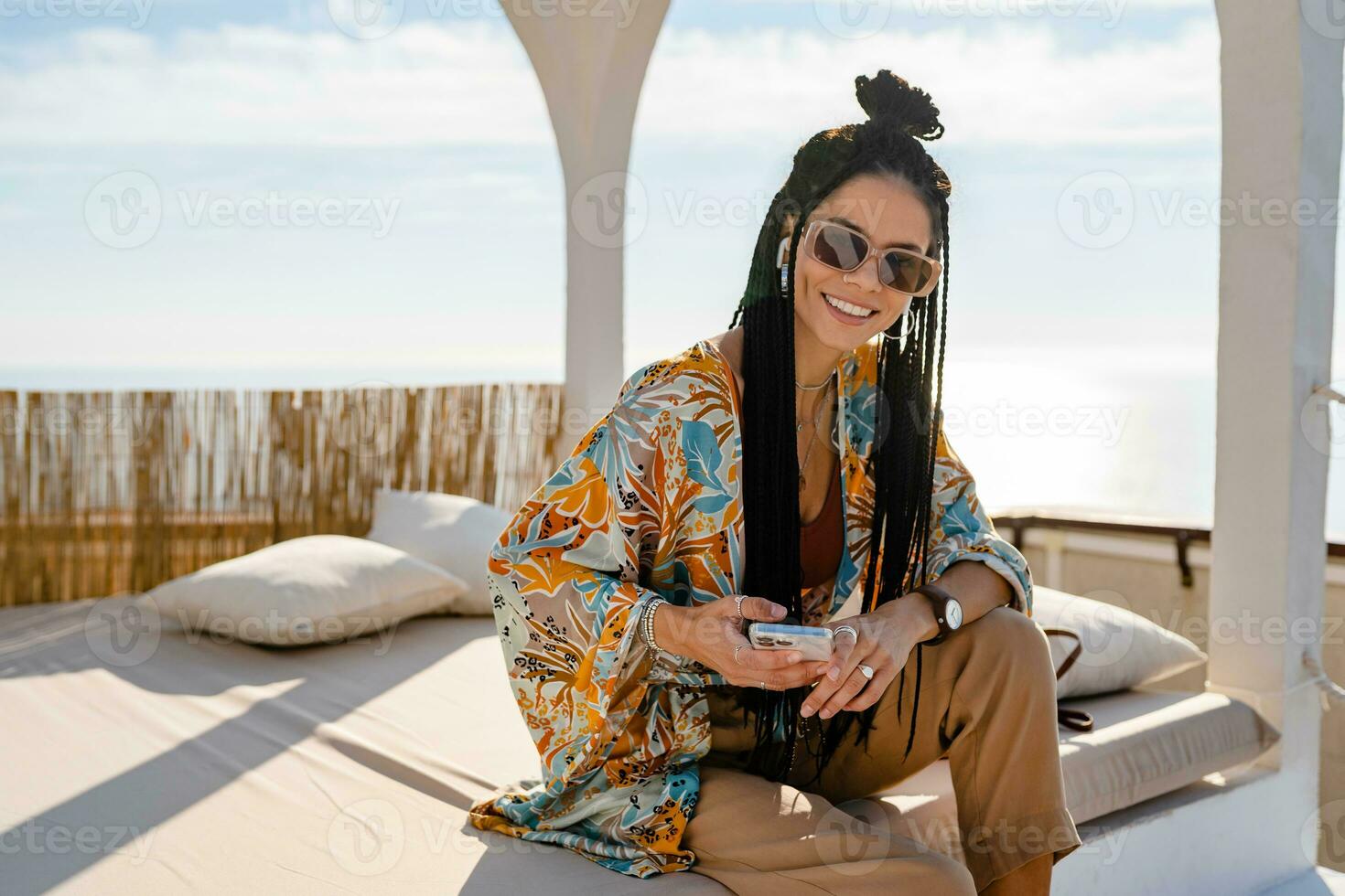 stylish pretty woman with african braids on sunny summer vacation photo