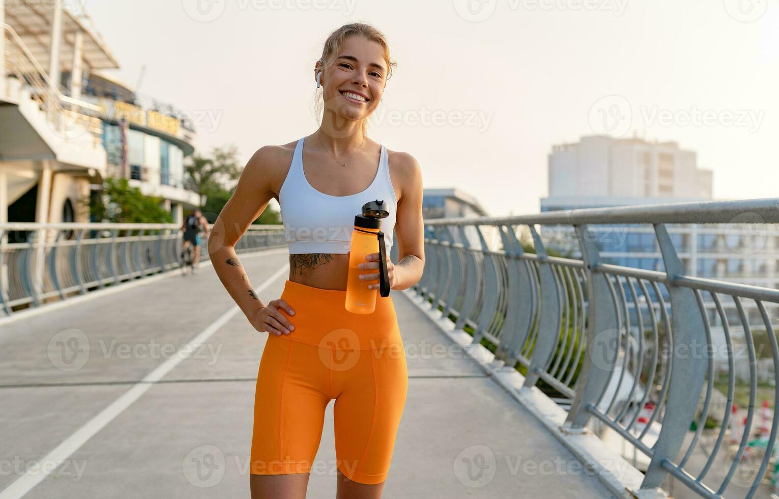 Stylish fit woman in sport outfit walking on sport square. Attractive  sportswoman, enjoying summer, training, outwork, happiness Stock Photo