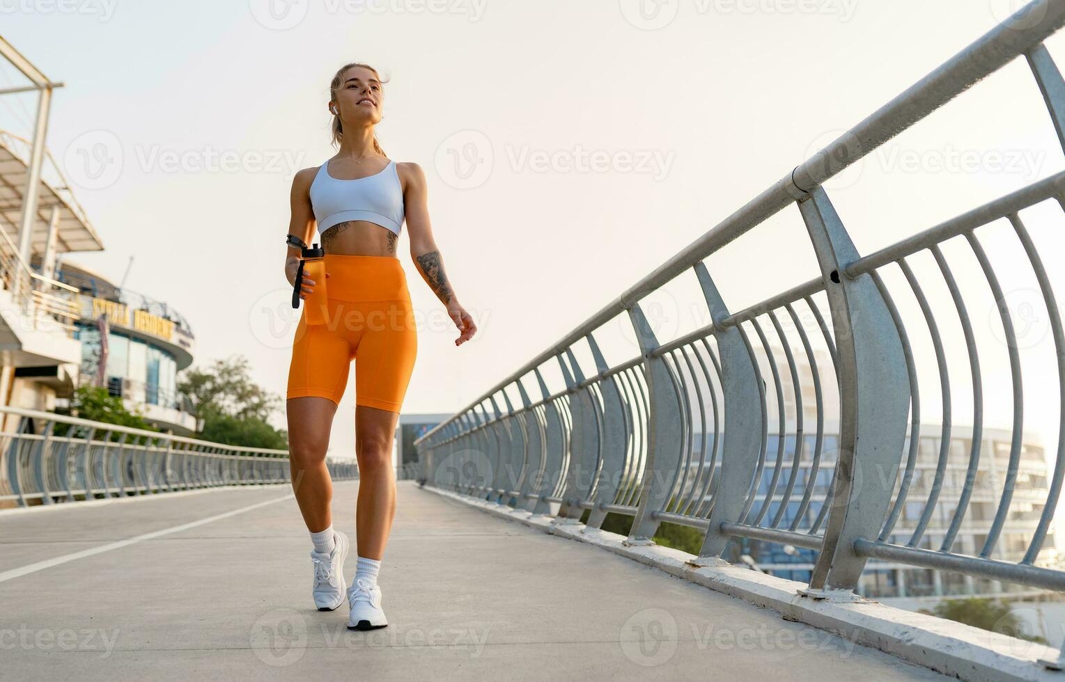 https://static.vecteezy.com/system/resources/previews/029/068/824/non_2x/pretty-young-smiling-woman-doing-sports-in-the-morning-in-stylish-sport-outfit-sportswear-skinny-strong-body-healthy-fit-lifestyle-photo.jpg