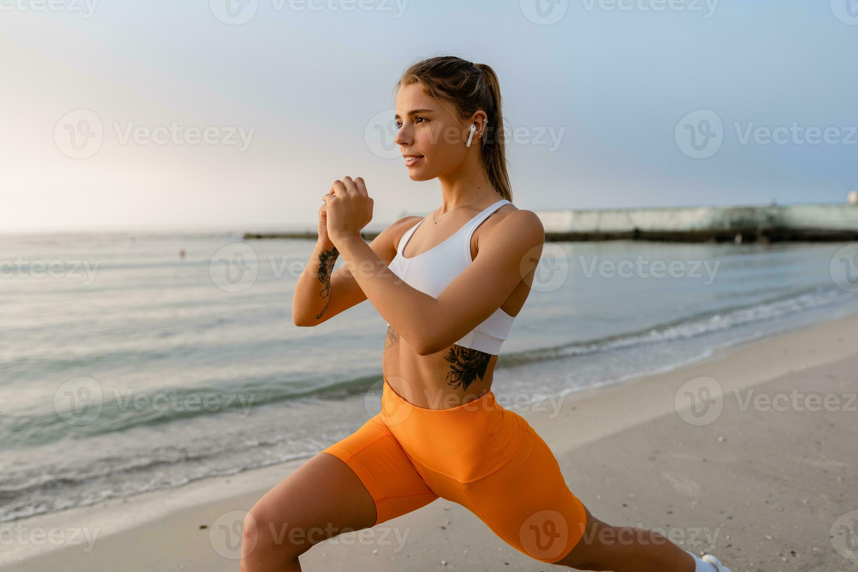 pretty young smiling woman doing sports in the morning in stylish