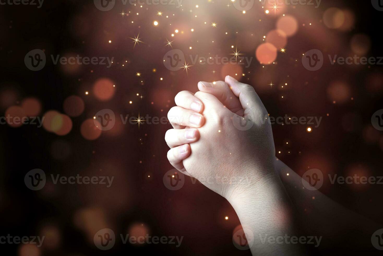 Praying hands of men with light shining from above. concept of prayer and faith, spirituality related to religion and belief. photo