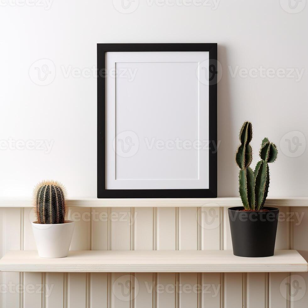a picture frame and a cactus in a pot photo