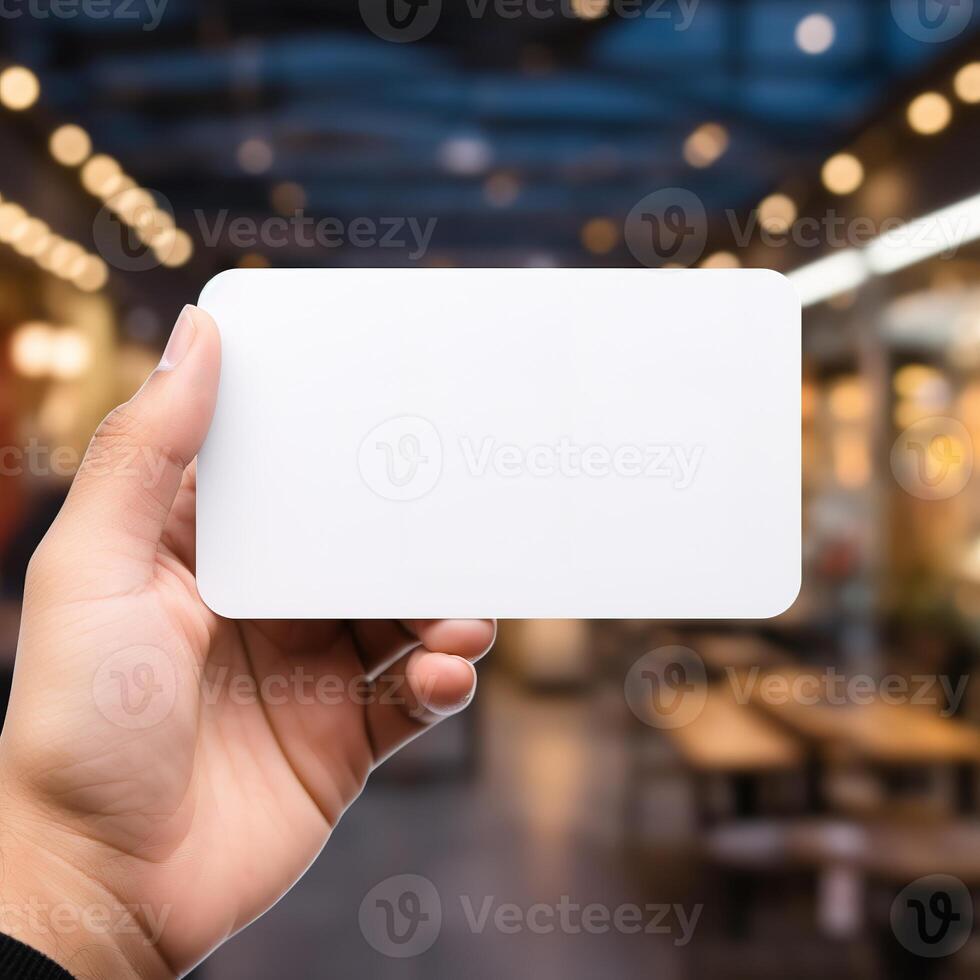 a hand holding a blank business white card photo
