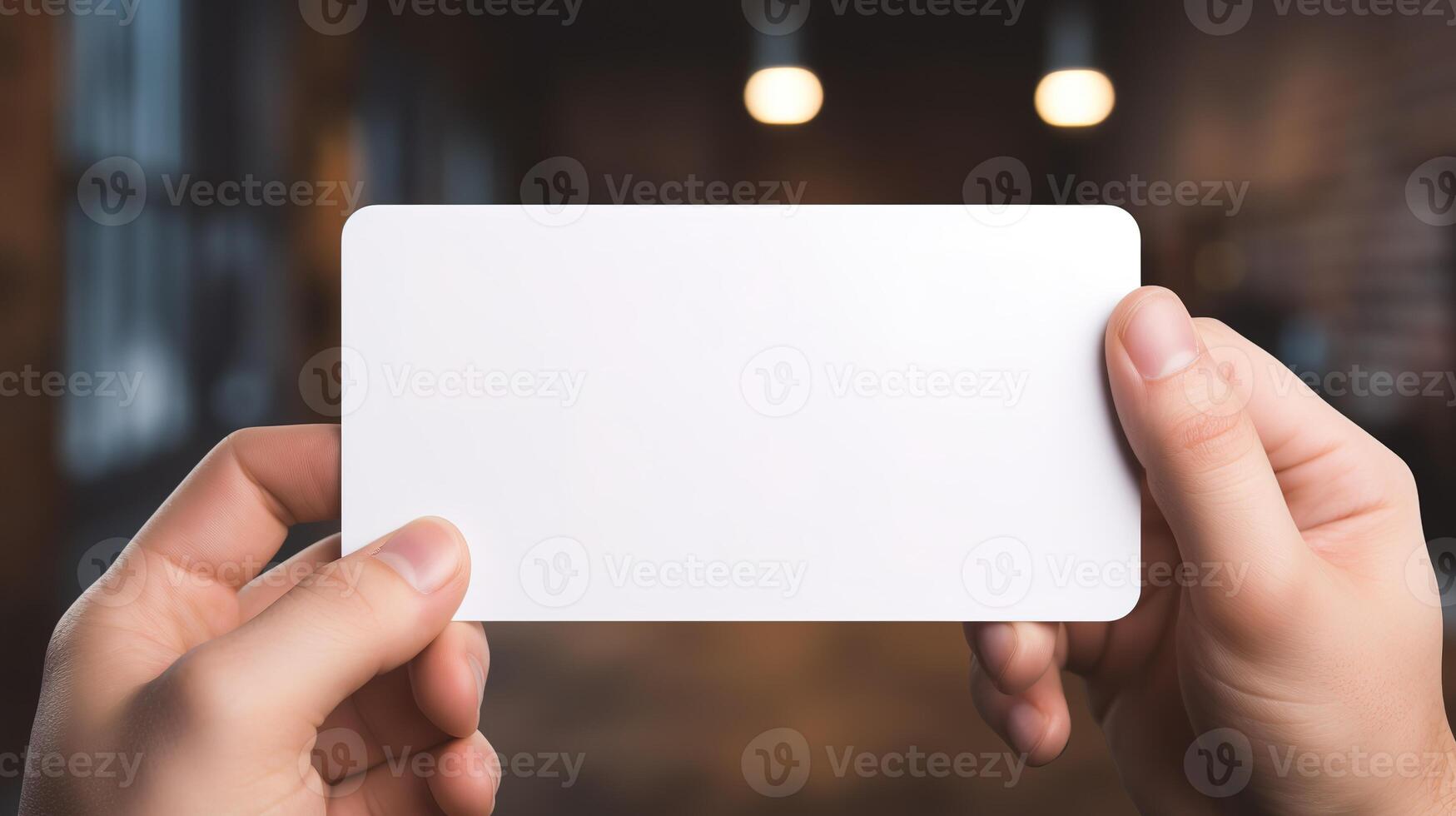 a hand holding a blank business white card photo
