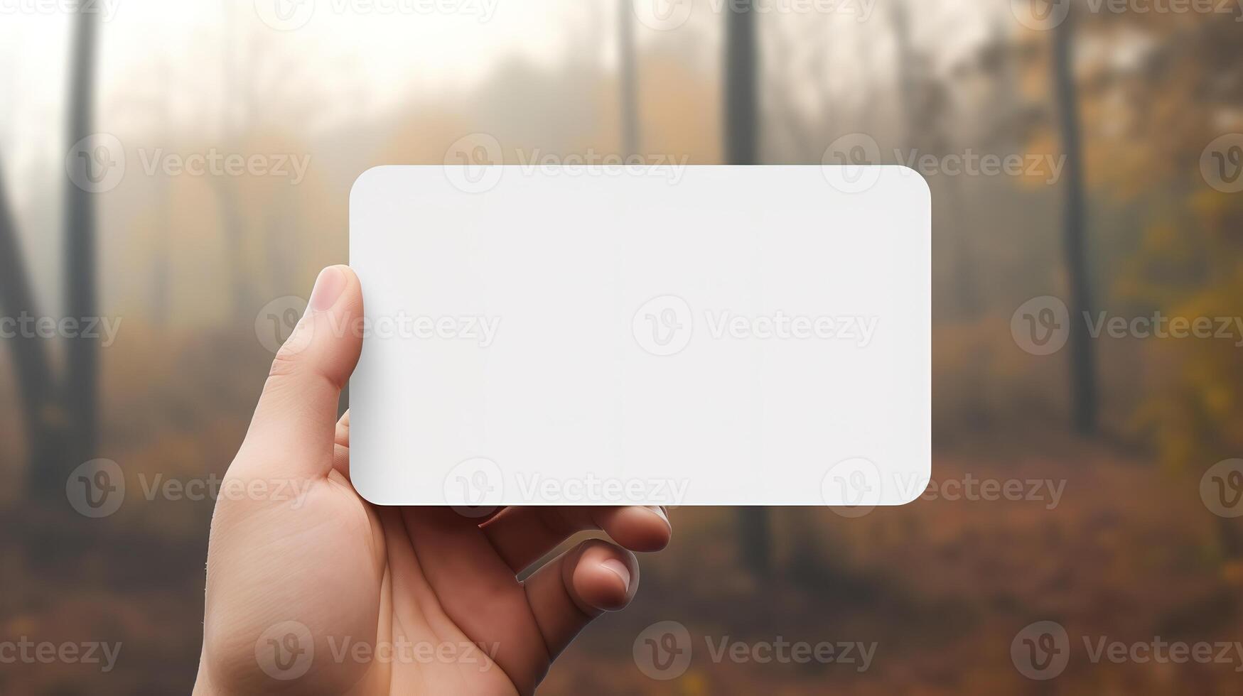 a hand holding a blank business white card photo