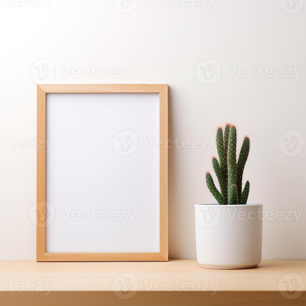 a picture frame and a cactus in a pot photo