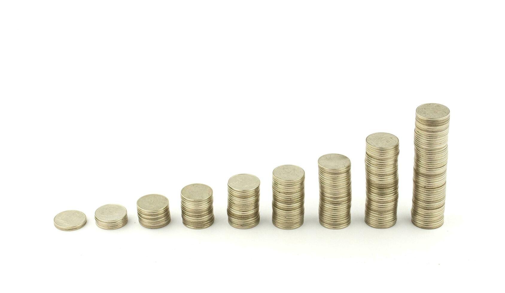 Golden coins stacks arranged as a graph isolated on white background. photo