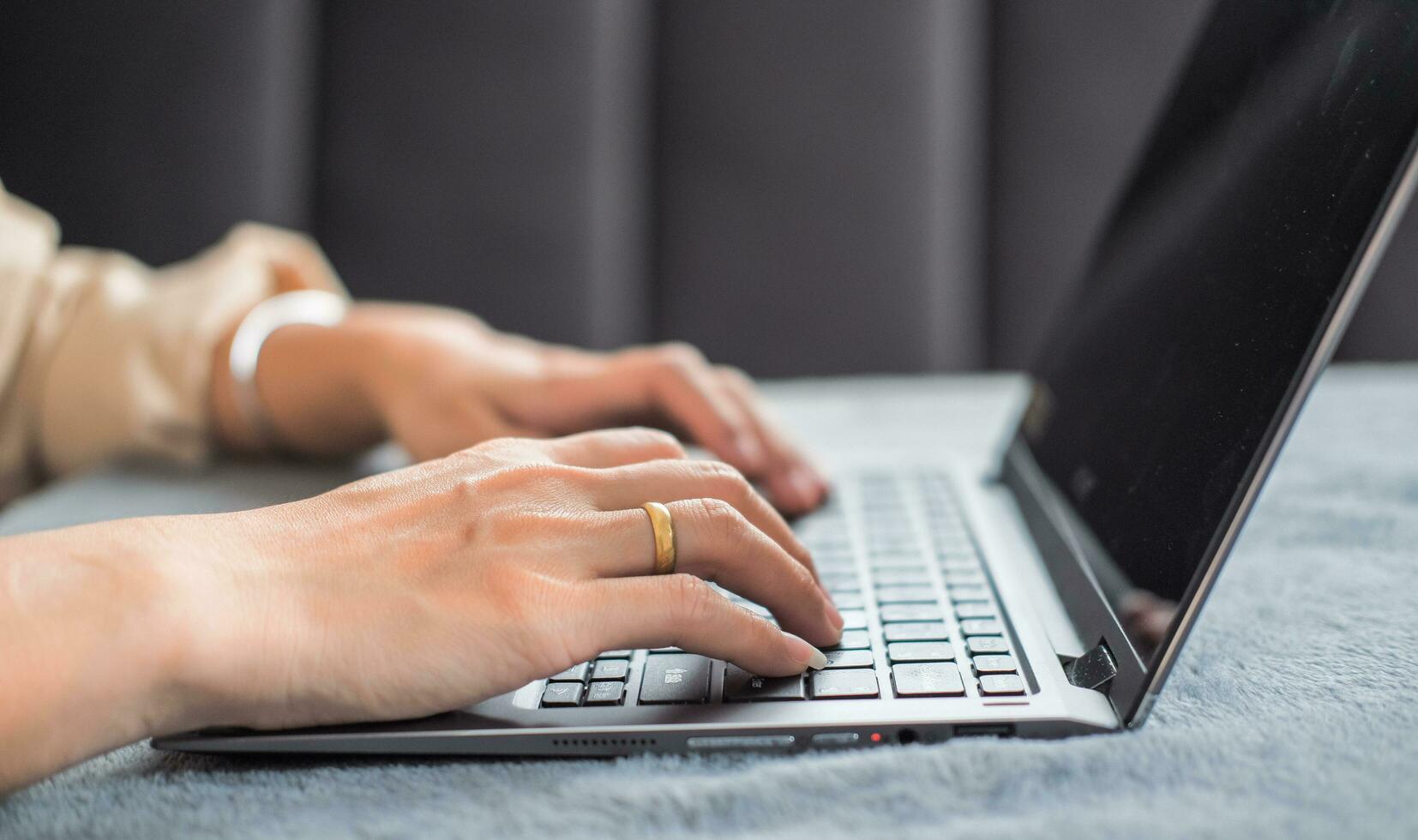 Woman typing work or chatting on laptop Suitable for making infographics. photo