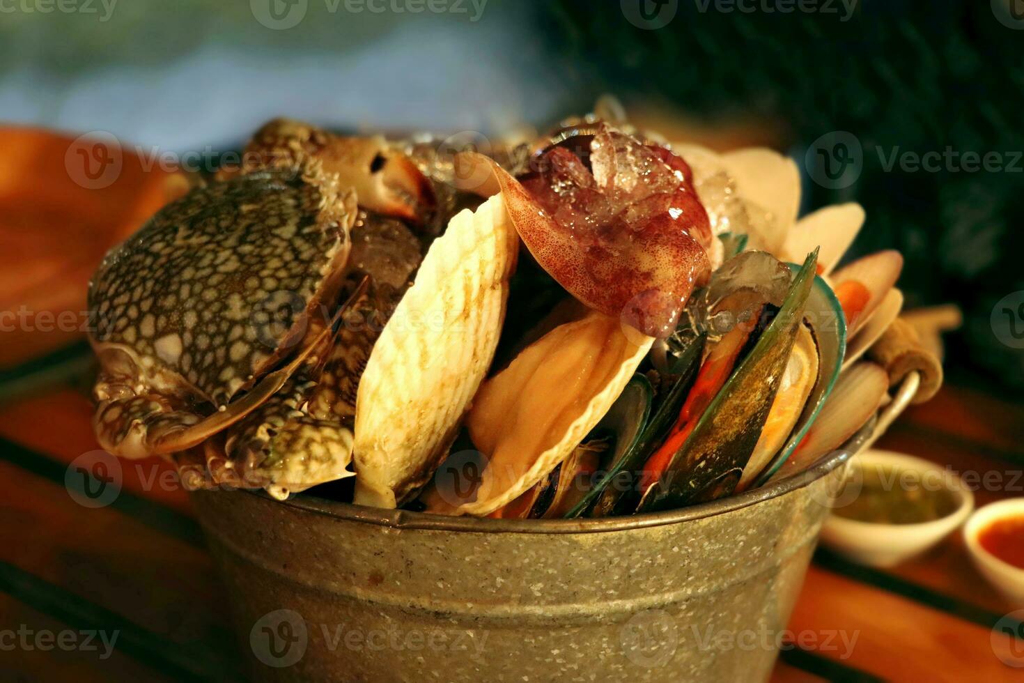 Fresh seafood in zinc tank such as crab, octopus, and shell for preparing the grilling in the restaurant photo