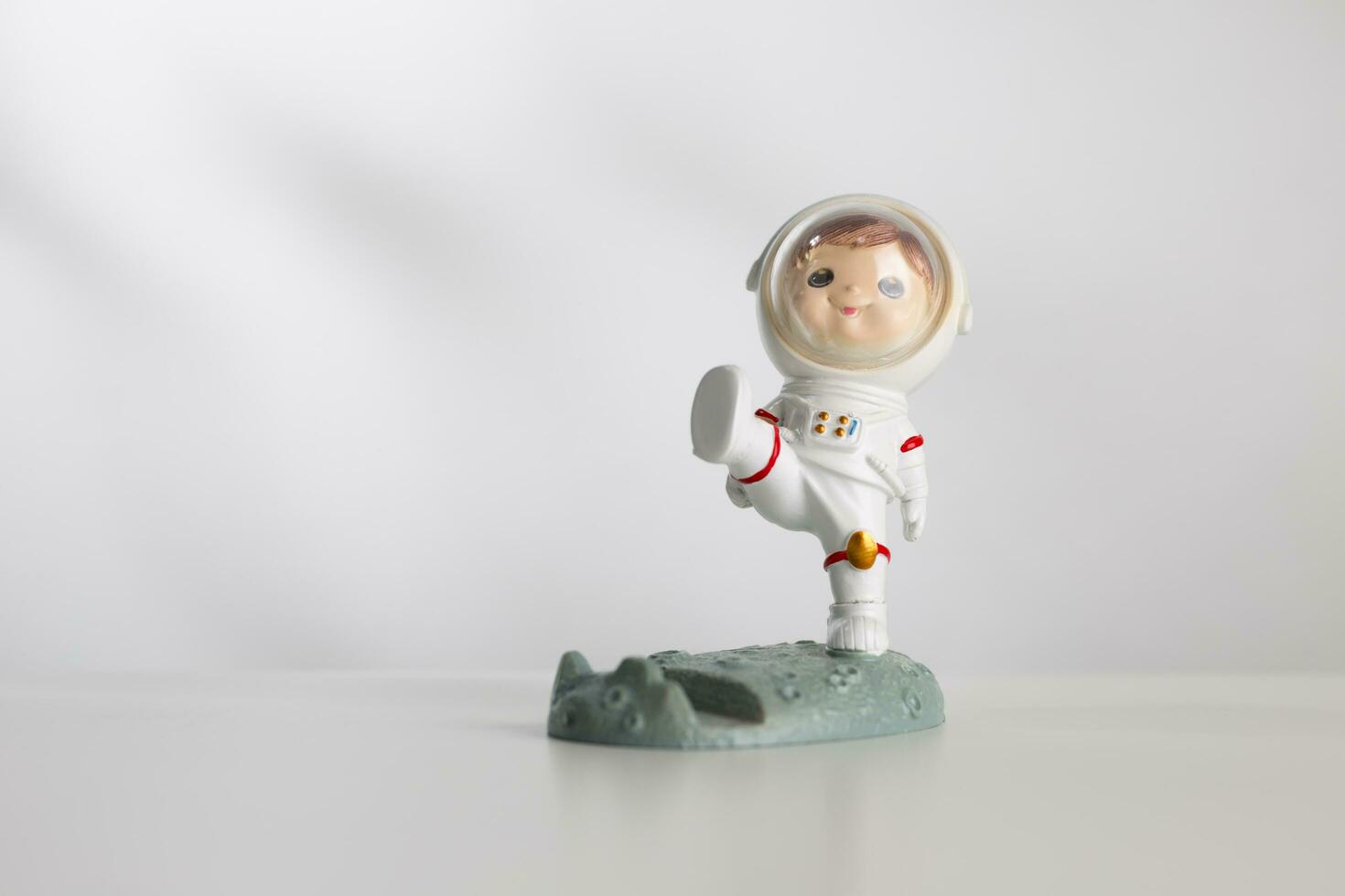 Man doll in space suit on a white table. photo
