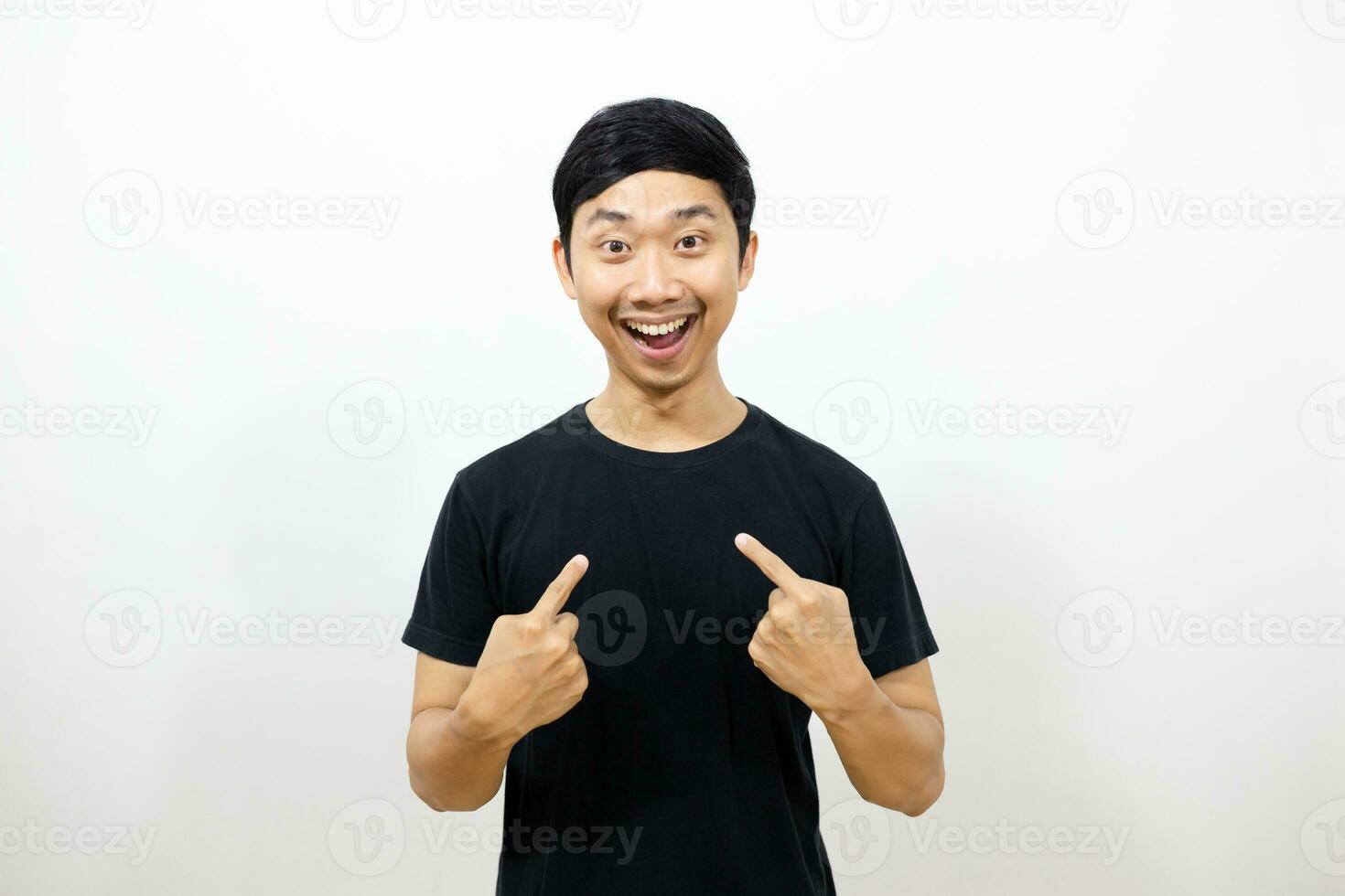 Positive asian man black shirt smile and gesture point finger at himself isolated photo