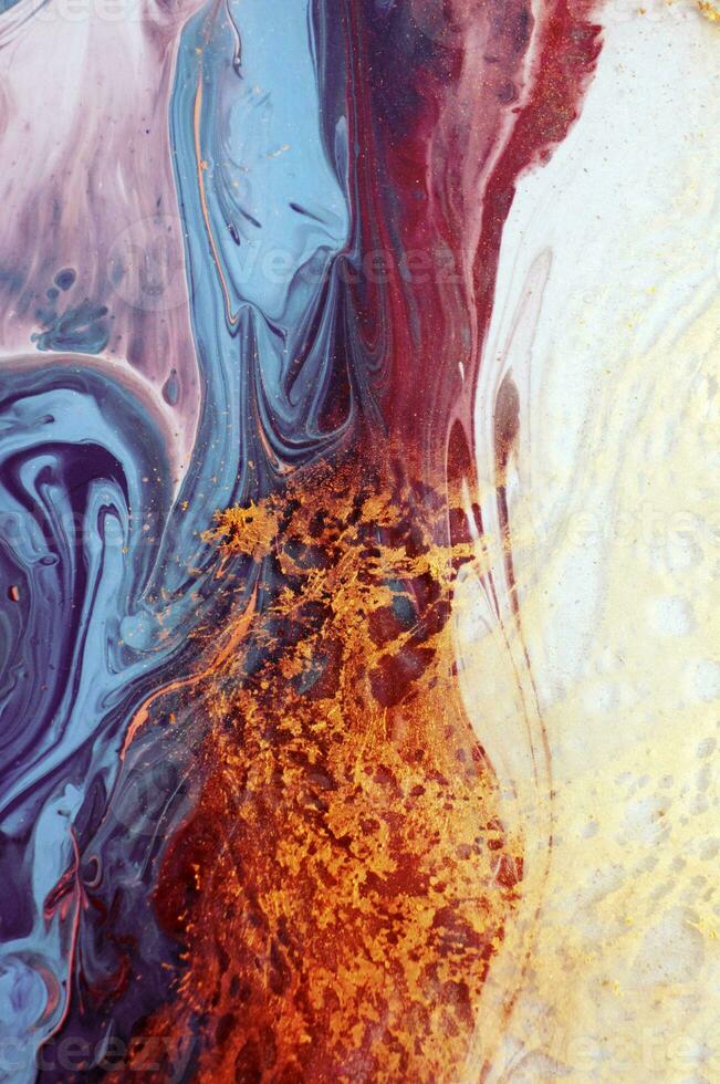Abstract created using the technique of liquid acrylic. Macro photography of the smallest details of a panting. The panting shows how overflows of shades and colors of paint resemble space motifs. photo