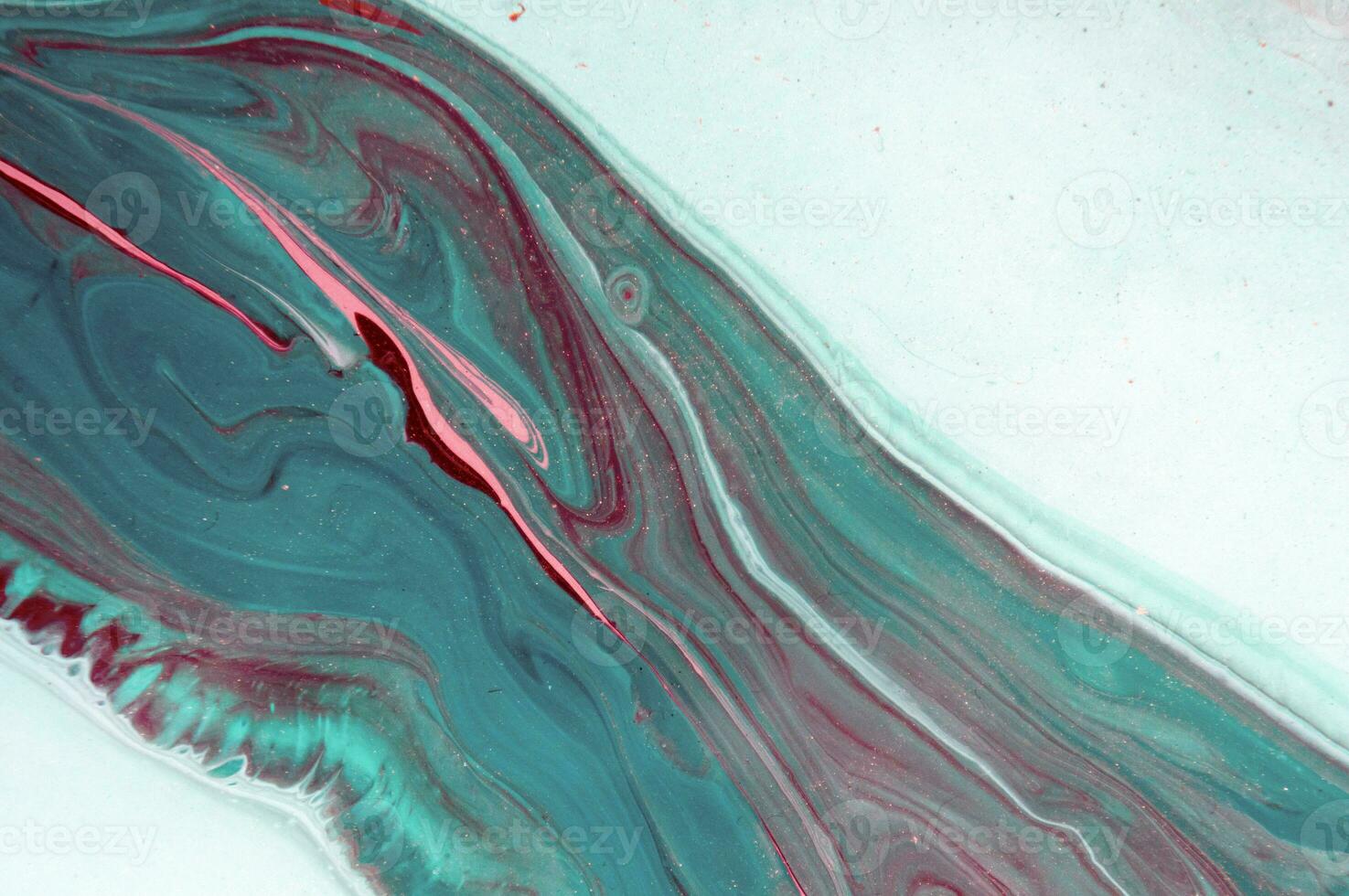 Abstract created using the technique of liquid acrylic. Macro photography of the smallest details of a panting. The panting shows how overflows of shades and colors of paint resemble space motifs. photo