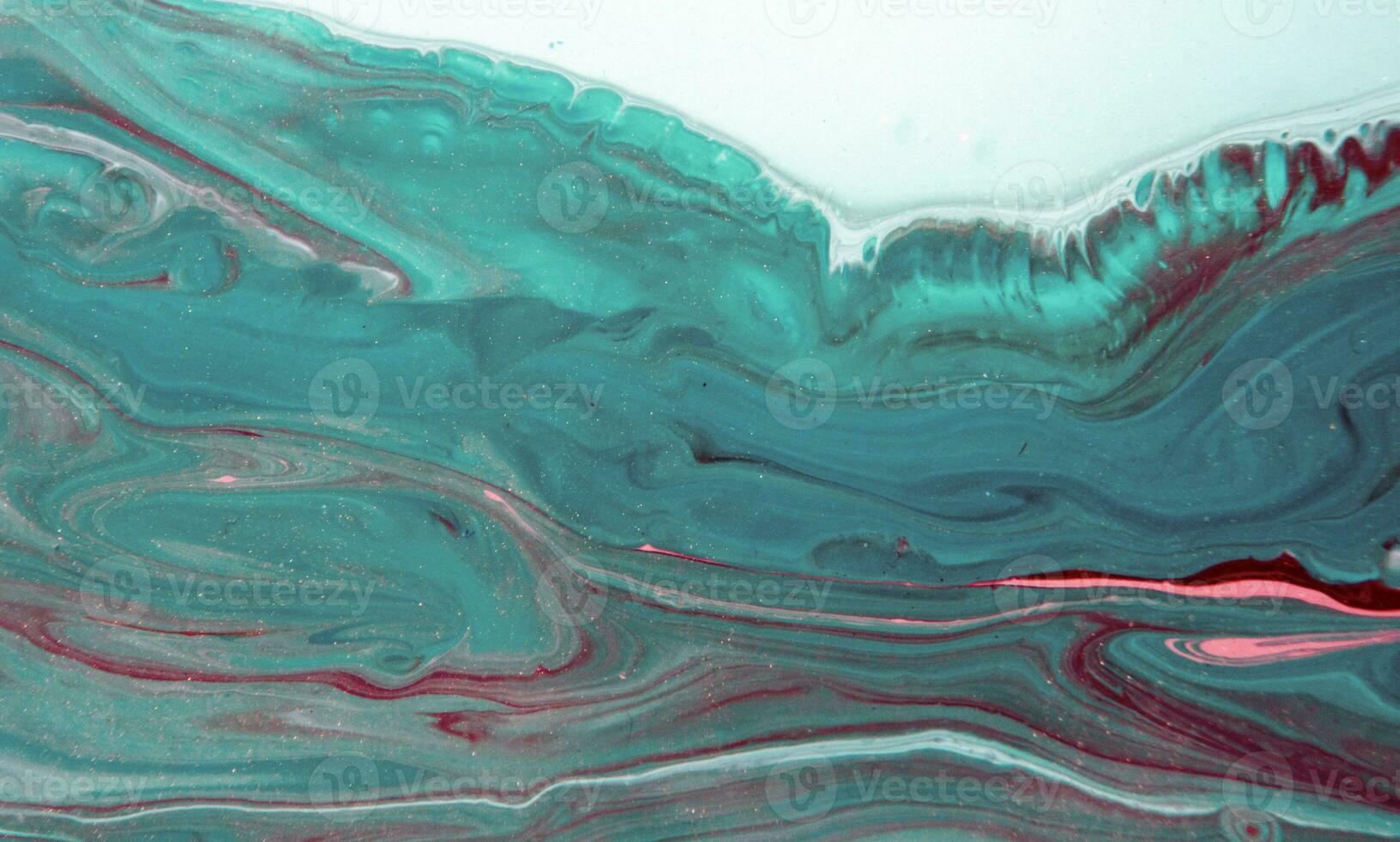 Abstract created using the technique of liquid acrylic. Macro photography of the smallest details of a panting. The panting shows how overflows of shades and colors of paint resemble space motifs. photo