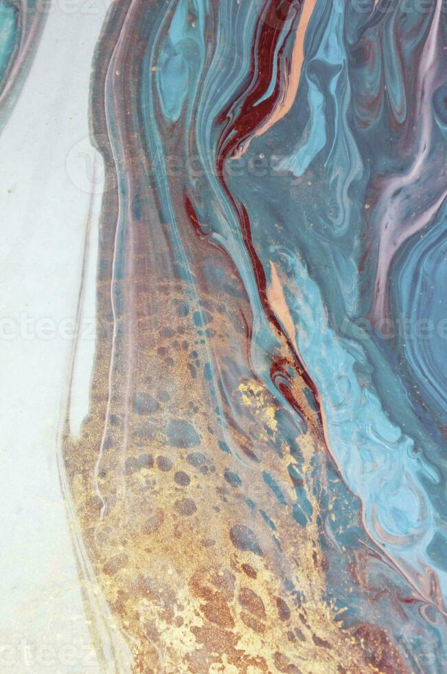 Abstract created using the technique of liquid acrylic. Macro photography of the smallest details of a panting. The panting shows how overflows of shades and colors of paint resemble space motifs. photo