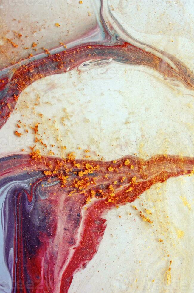Abstract created using the technique of liquid acrylic. Macro photography of the smallest details of a panting. The panting shows how overflows of shades and colors of paint resemble space motifs. photo