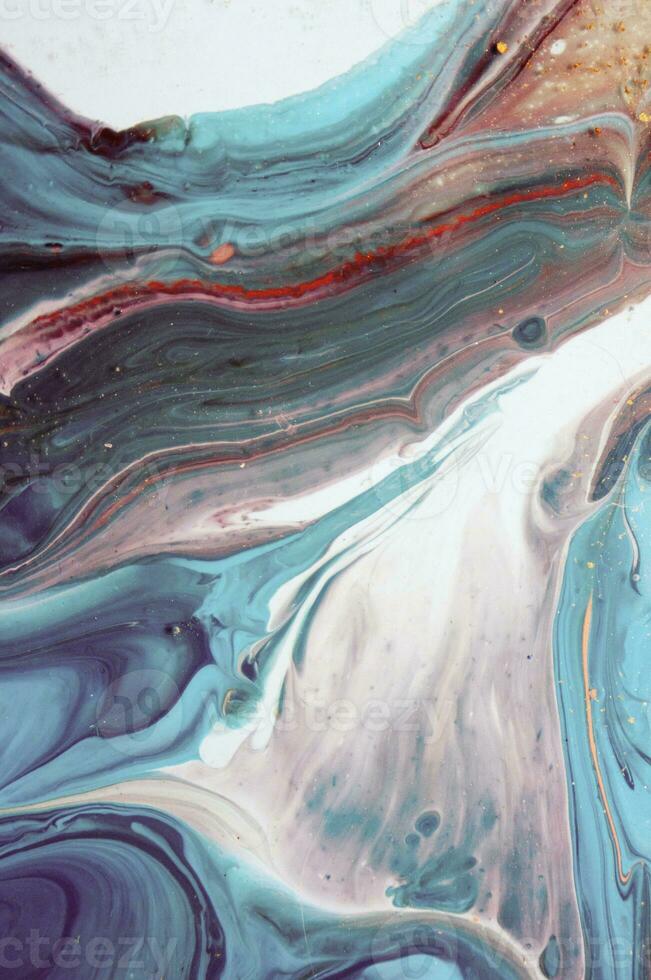 Abstract created using the technique of liquid acrylic. Macro photography of the smallest details of a panting. The panting shows how overflows of shades and colors of paint resemble space motifs. photo