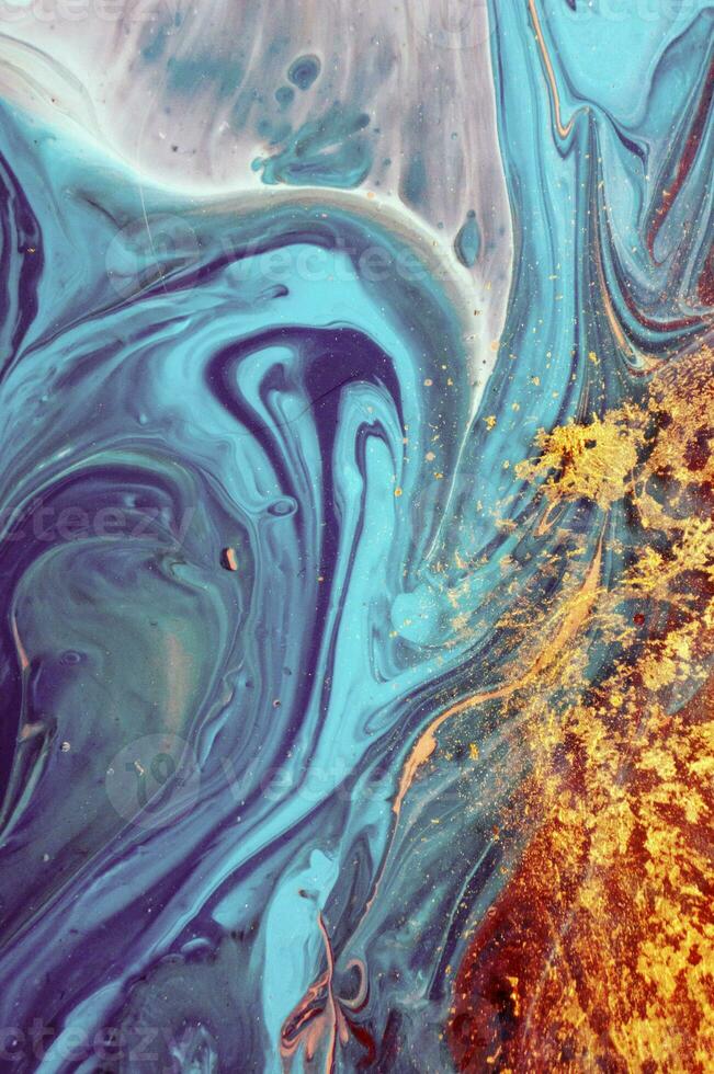 Abstract created using the technique of liquid acrylic. Macro photography of the smallest details of a panting. The panting shows how overflows of shades and colors of paint resemble space motifs. photo