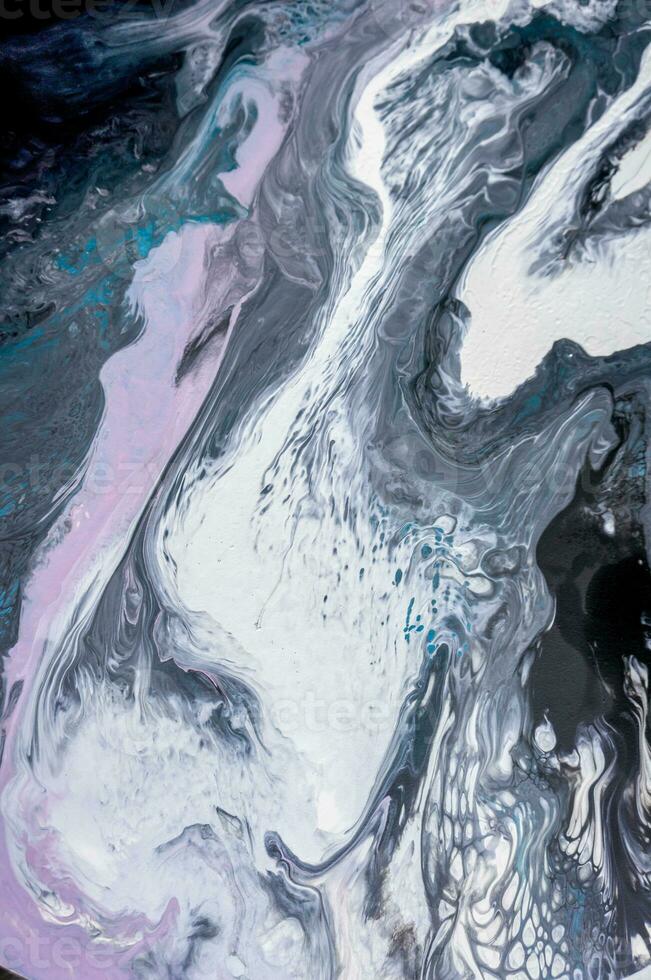 Abstract created using the technique of liquid acrylic. Macro photography of the smallest details of a picture. The picture shows how overflows of shades and colors of paint resemble space motifs. photo