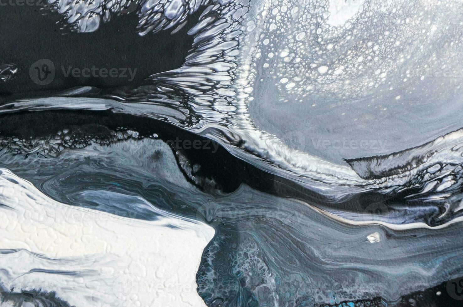 Abstract created using the technique of liquid acrylic. Macro photography of the smallest details of a picture. The picture shows how overflows of shades and colors of paint resemble space motifs. photo