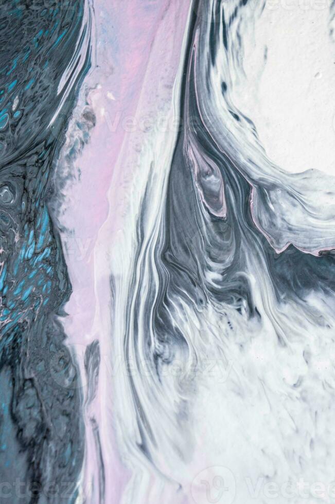 Abstract created using the technique of liquid acrylic. Macro photography of the smallest details of a picture. The picture shows how overflows of shades and colors of paint resemble space motifs. photo