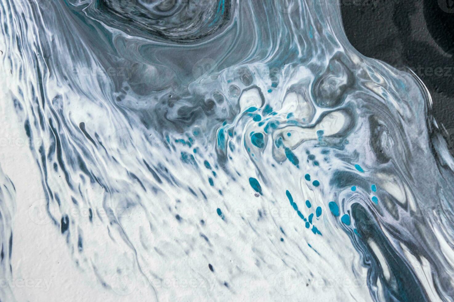 Abstract created using the technique of liquid acrylic. Macro photography of the smallest details of a picture. The picture shows how overflows of shades and colors of paint resemble space motifs. photo