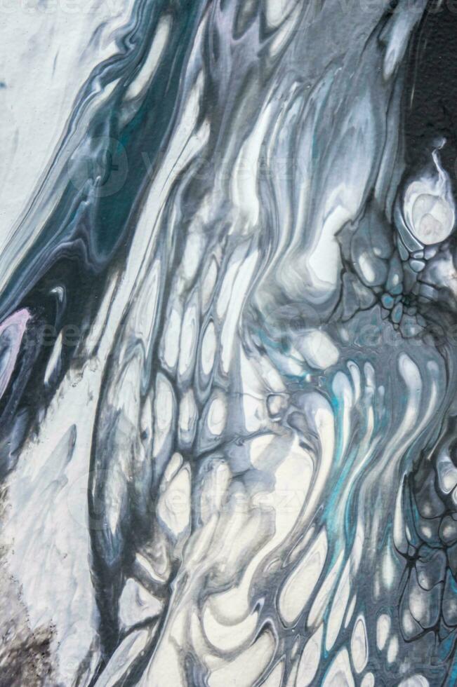 Abstract created using the technique of liquid acrylic. Macro photography of the smallest details of a picture. The picture shows how overflows of shades and colors of paint resemble space motifs. photo