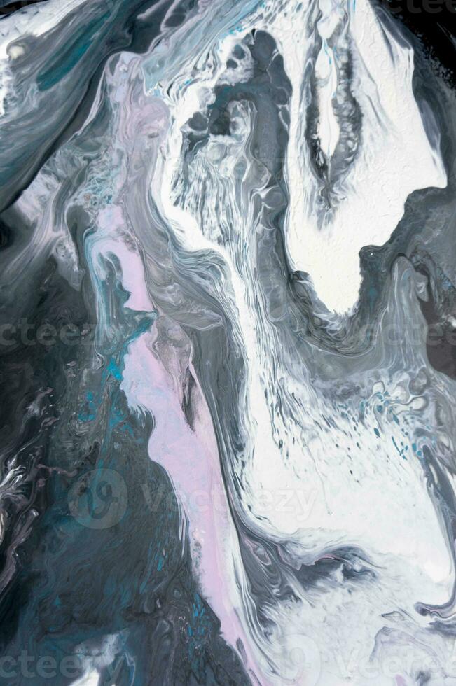 Abstract created using the technique of liquid acrylic. Macro photography of the smallest details of a picture. The picture shows how overflows of shades and colors of paint resemble space motifs. photo