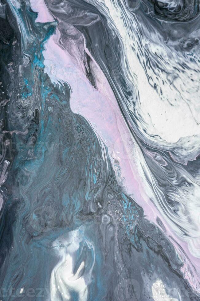 Abstract created using the technique of liquid acrylic. Macro photography of the smallest details of a picture. The picture shows how overflows of shades and colors of paint resemble space motifs. photo