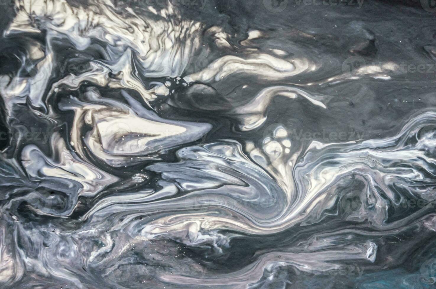 Abstract created using the technique of liquid acrylic. Macro photography of the smallest details of a picture. The picture shows how overflows of shades and colors of paint resemble space motifs. photo