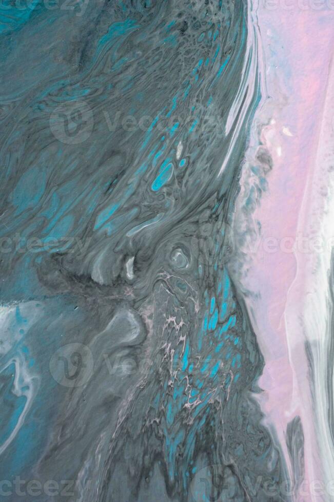 Abstract created using the technique of liquid acrylic. Macro photography of the smallest details of a picture. The picture shows how overflows of shades and colors of paint resemble space motifs. photo