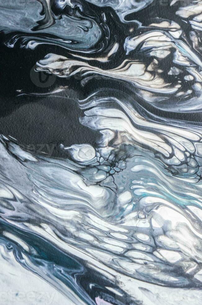 Abstract created using the technique of liquid acrylic. Macro photography of the smallest details of a picture. The picture shows how overflows of shades and colors of paint resemble space motifs. photo