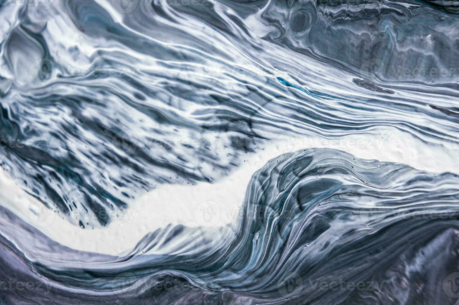Abstract created using the technique of liquid acrylic. Macro photography of the smallest details of a picture. The picture shows how overflows of shades and colors of paint resemble space motifs. photo