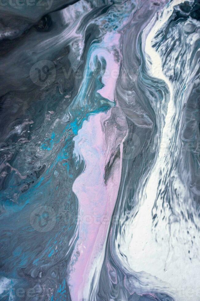 Abstract created using the technique of liquid acrylic. Macro photography of the smallest details of a picture. The picture shows how overflows of shades and colors of paint resemble space motifs. photo