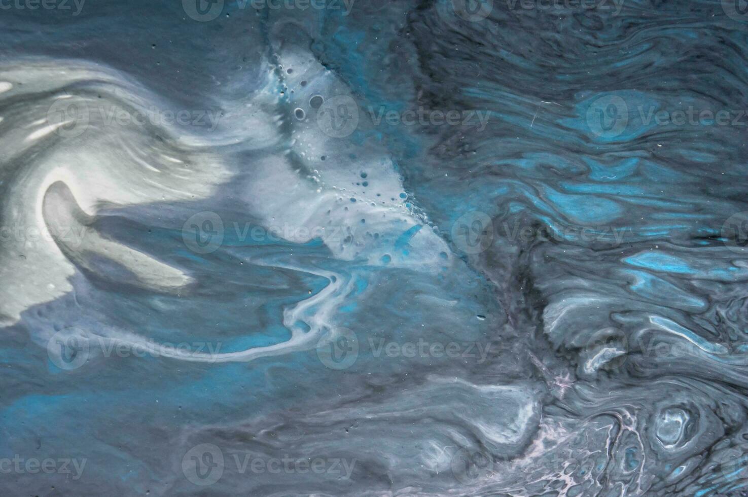 Abstract created using the technique of liquid acrylic. Macro photography of the smallest details of a picture. The picture shows how overflows of shades and colors of paint resemble space motifs. photo