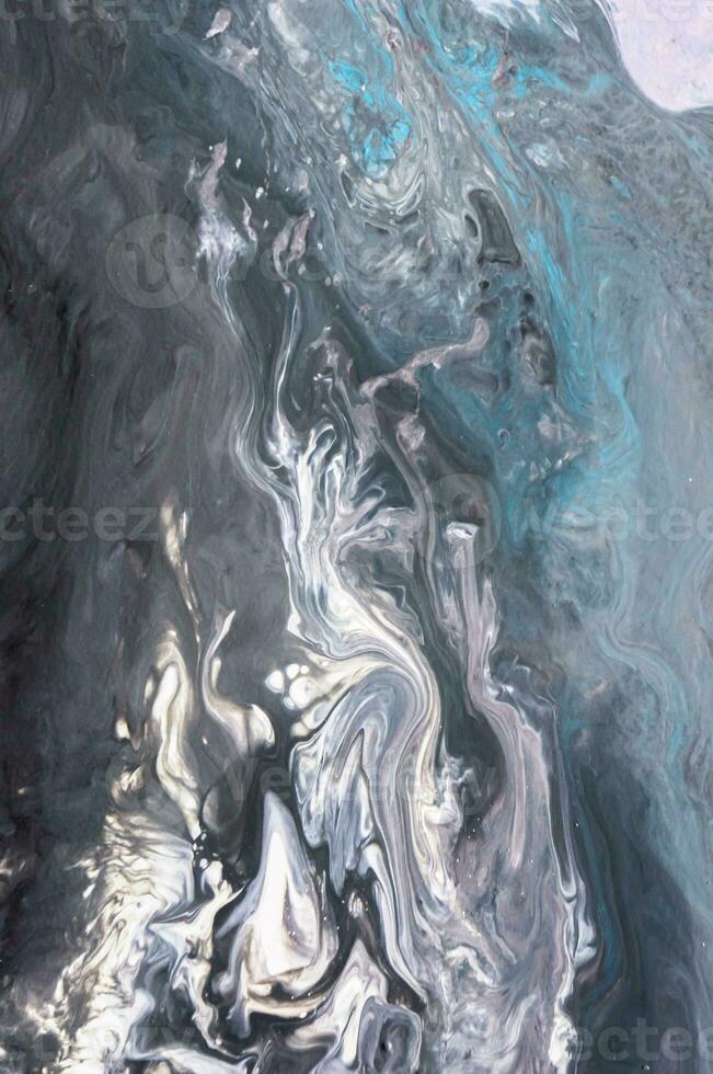 Abstract created using the technique of liquid acrylic. Macro photography of the smallest details of a picture. The picture shows how overflows of shades and colors of paint resemble space motifs. photo