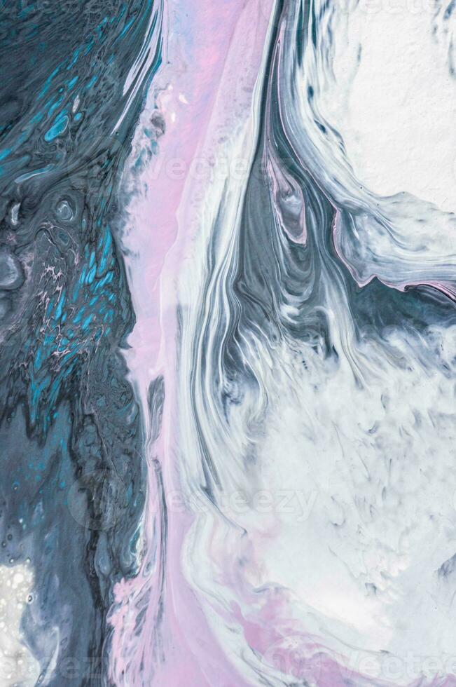 Abstract created using the technique of liquid acrylic. Macro photography of the smallest details of a picture. The picture shows how overflows of shades and colors of paint resemble space motifs. photo