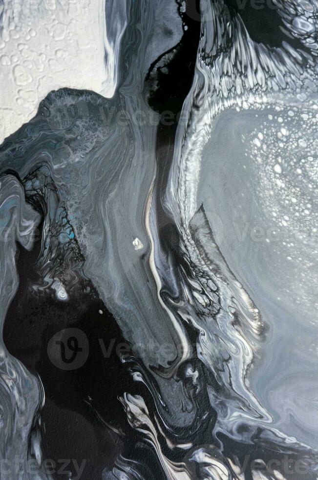 Abstract created using the technique of liquid acrylic. Macro photography of the smallest details of a picture. The picture shows how overflows of shades and colors of paint resemble space motifs. photo